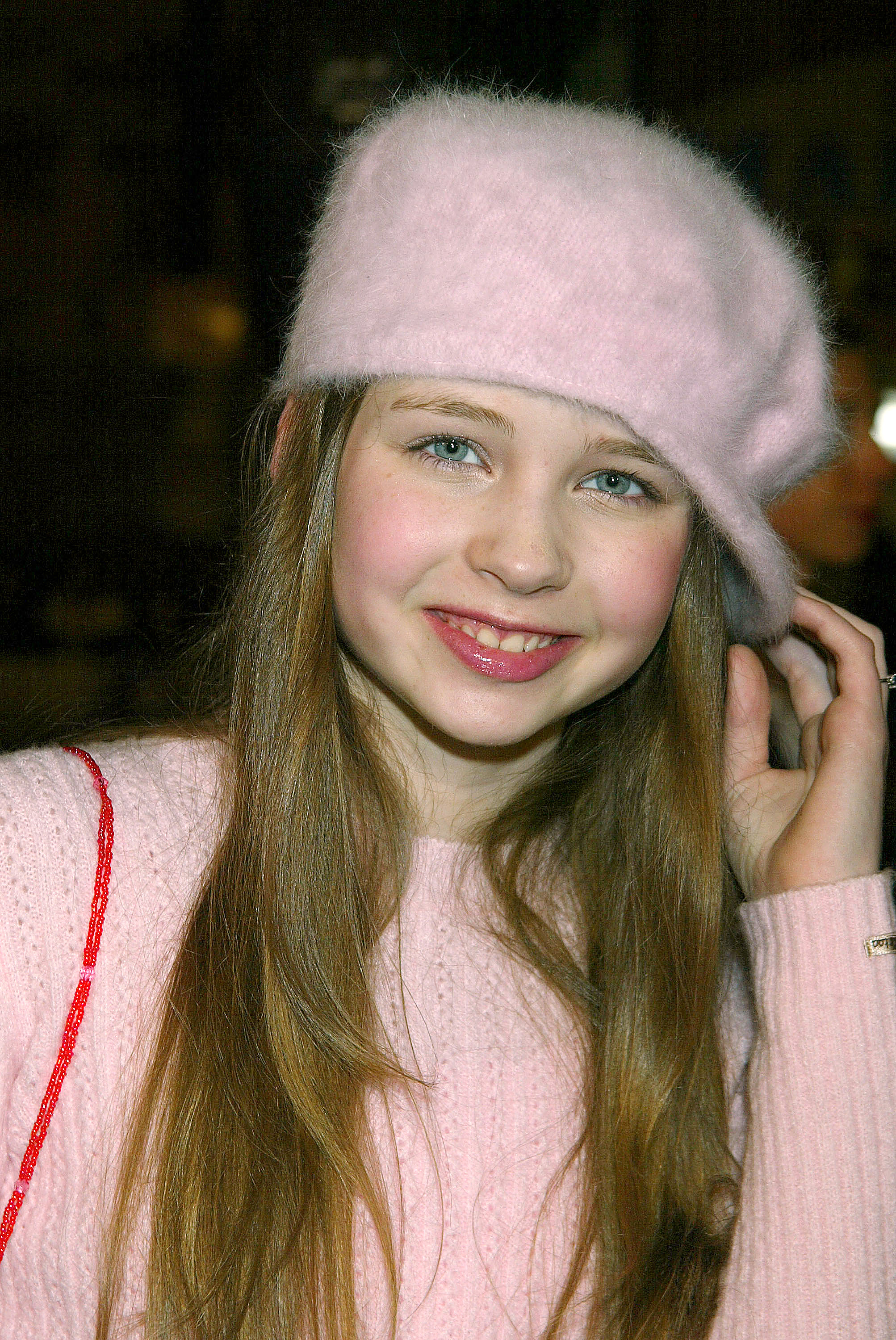 In einem rosa Pullover und einer dazu passenden Baskenmütze kommt Daveigh Chase zur Premiere von „Along Came Polly“ in Grauman's Chinese Theatre während des Höhepunkts ihres frühen Hollywood-Erfolgs. | Quelle: Getty Images