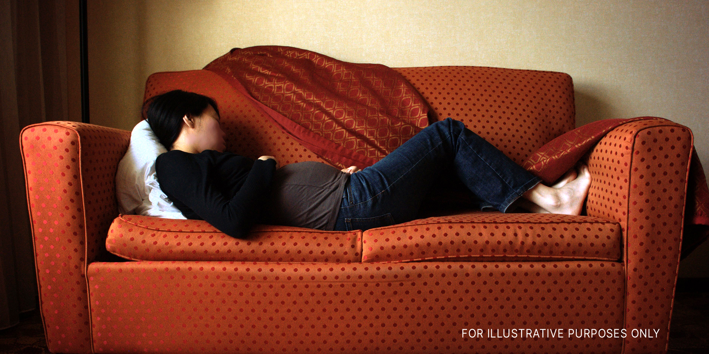 Eine schwangere Frau, die auf der Couch schläft | Quelle: Flickr.com/photos/koadmunkee/