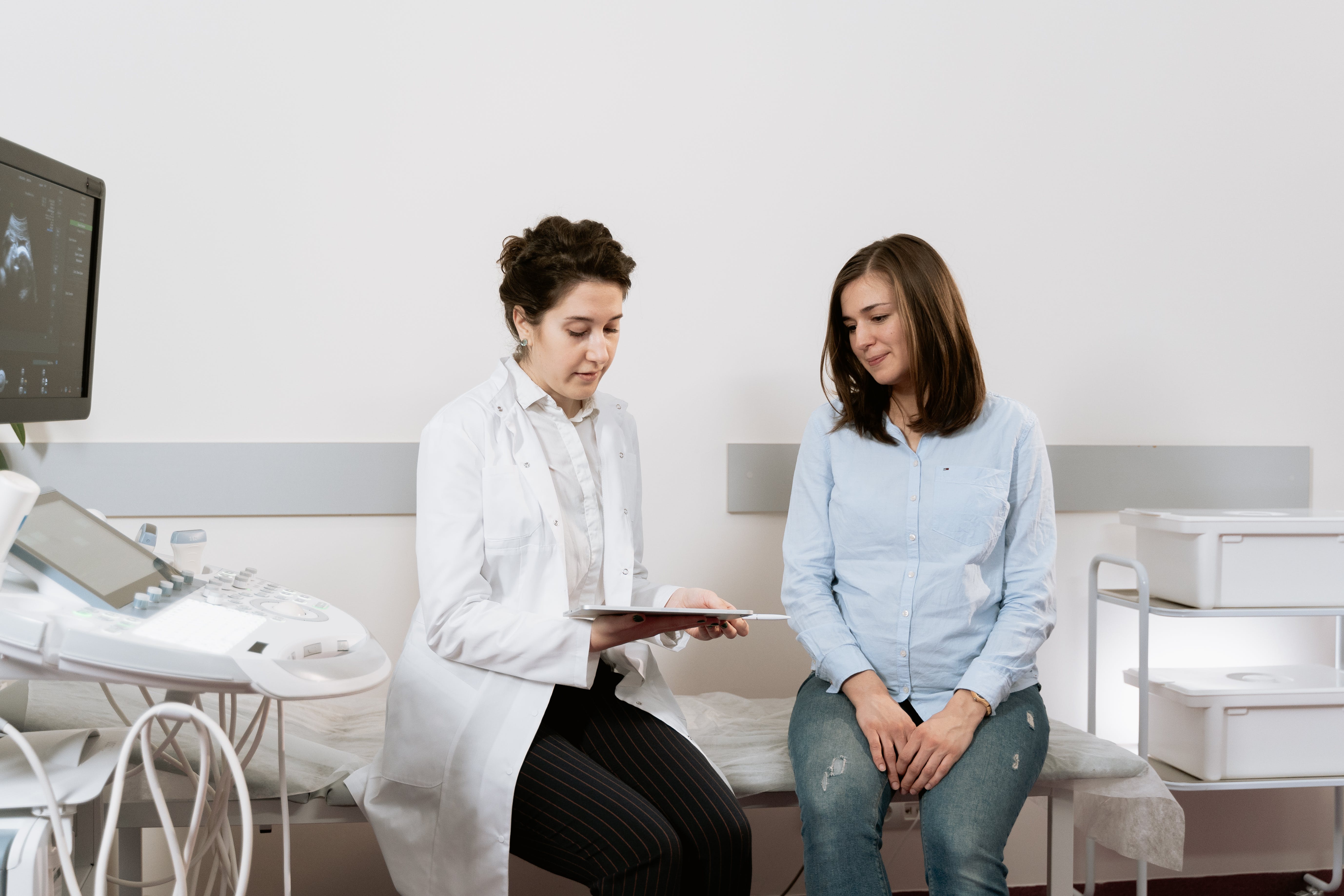 Eine schwangere Frau im Gespräch mit einem Arzt. | Quelle: Pexels