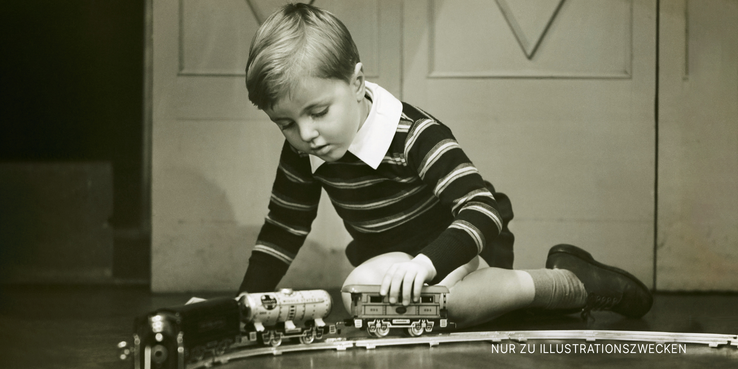 Kleiner Junge spielt mit einer Spielzeugeisenbahn | Quelle: Getty Images