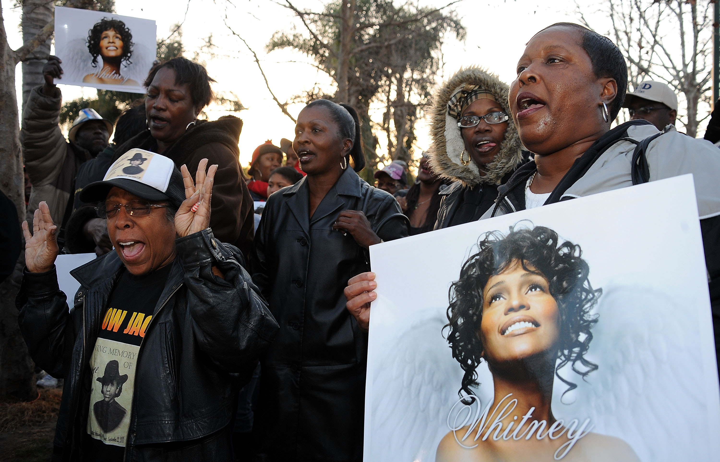 Fans halten Plakate von Whitney Houston bei ihrer Mahnwache im Leimert Park in Los Angeles, Kalifornien am 13. Februar 2012 | Quelle: Getty Images