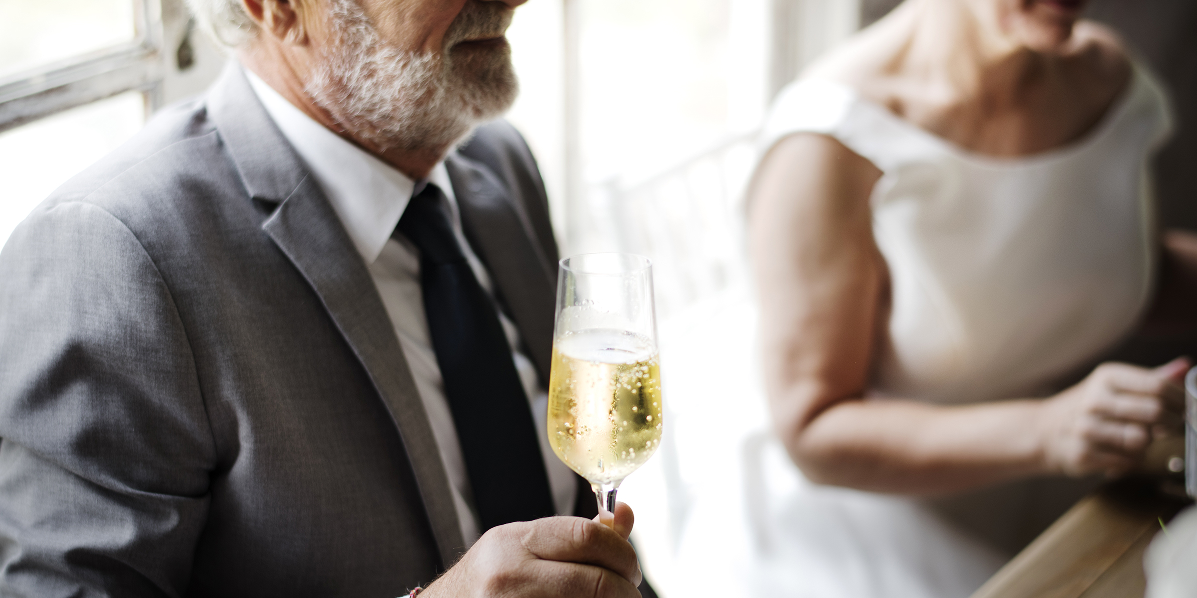 Ein Mann hält eine Sektflöte | Quelle: Shutterstock