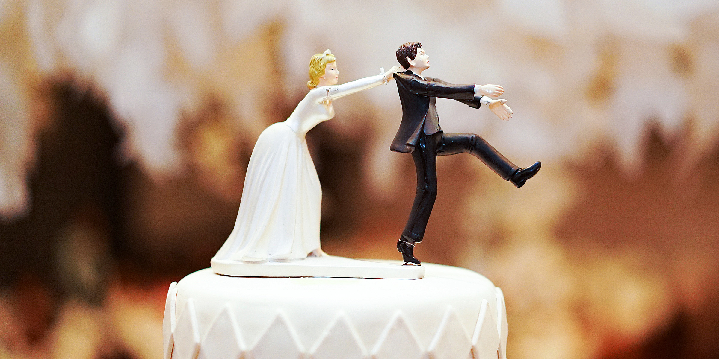 Braut und Bräutigam Puppe auf einer Torte | Quelle: Shutterstock