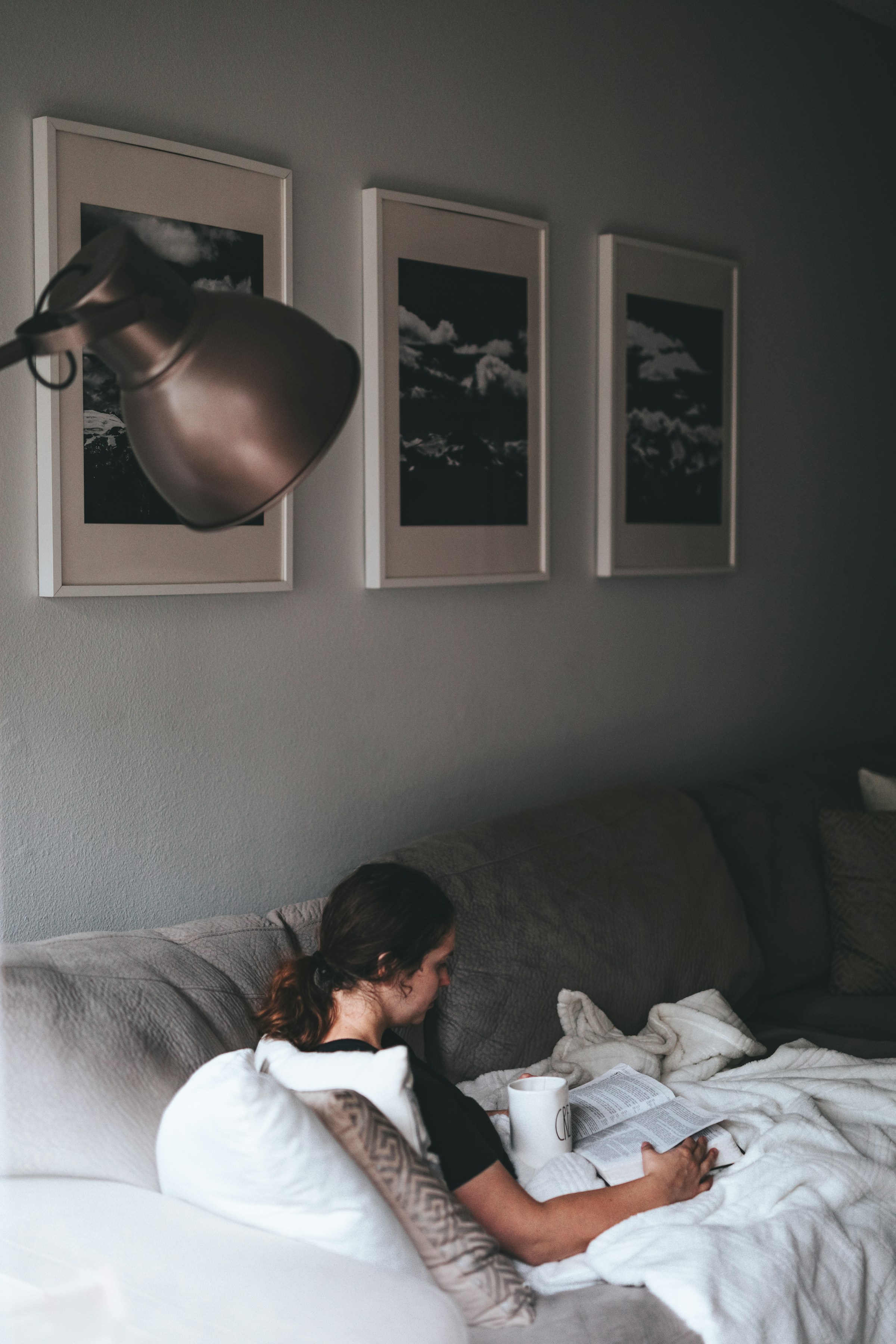 Eine lesende Frau auf einer Couch | Quelle: Unsplash